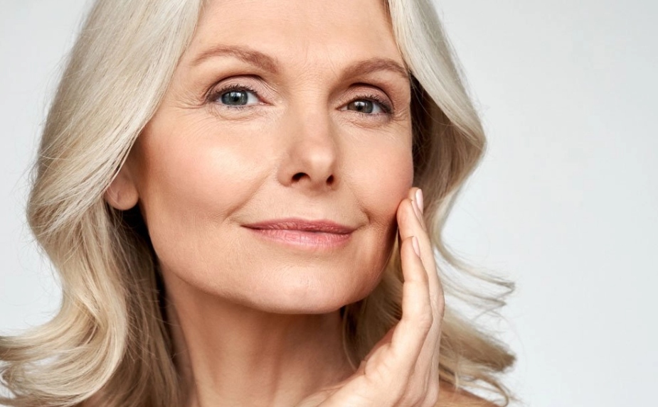 Middle aged woman doing skin care treatment