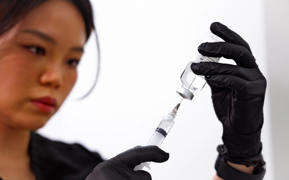Woman putting medicine injection