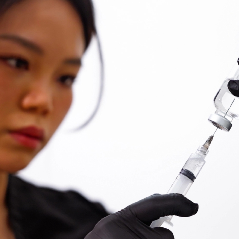 Woman using needle to give medication